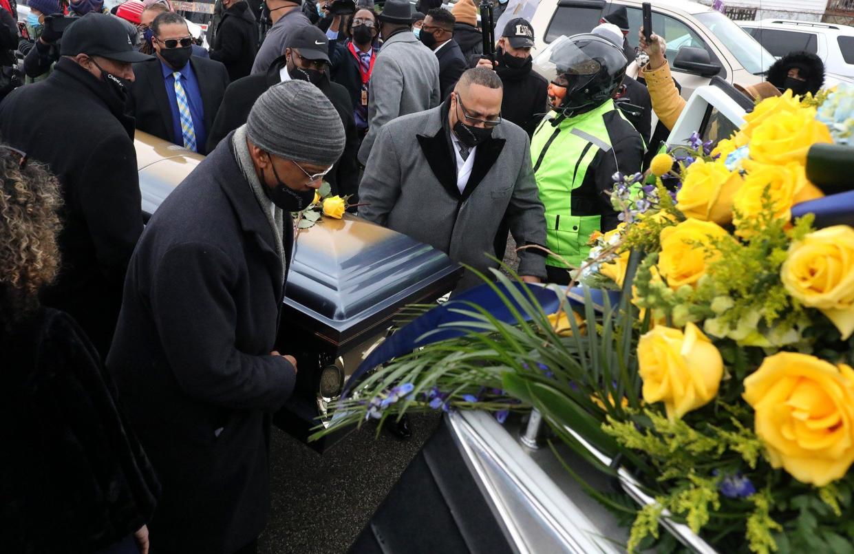 The casket of Andre Hill is moved from a horse drawn carriage to a hearse following funeral services on Tuesday, Jan. 5, near the Brentnell Community Center in Columbus, Ohio. 