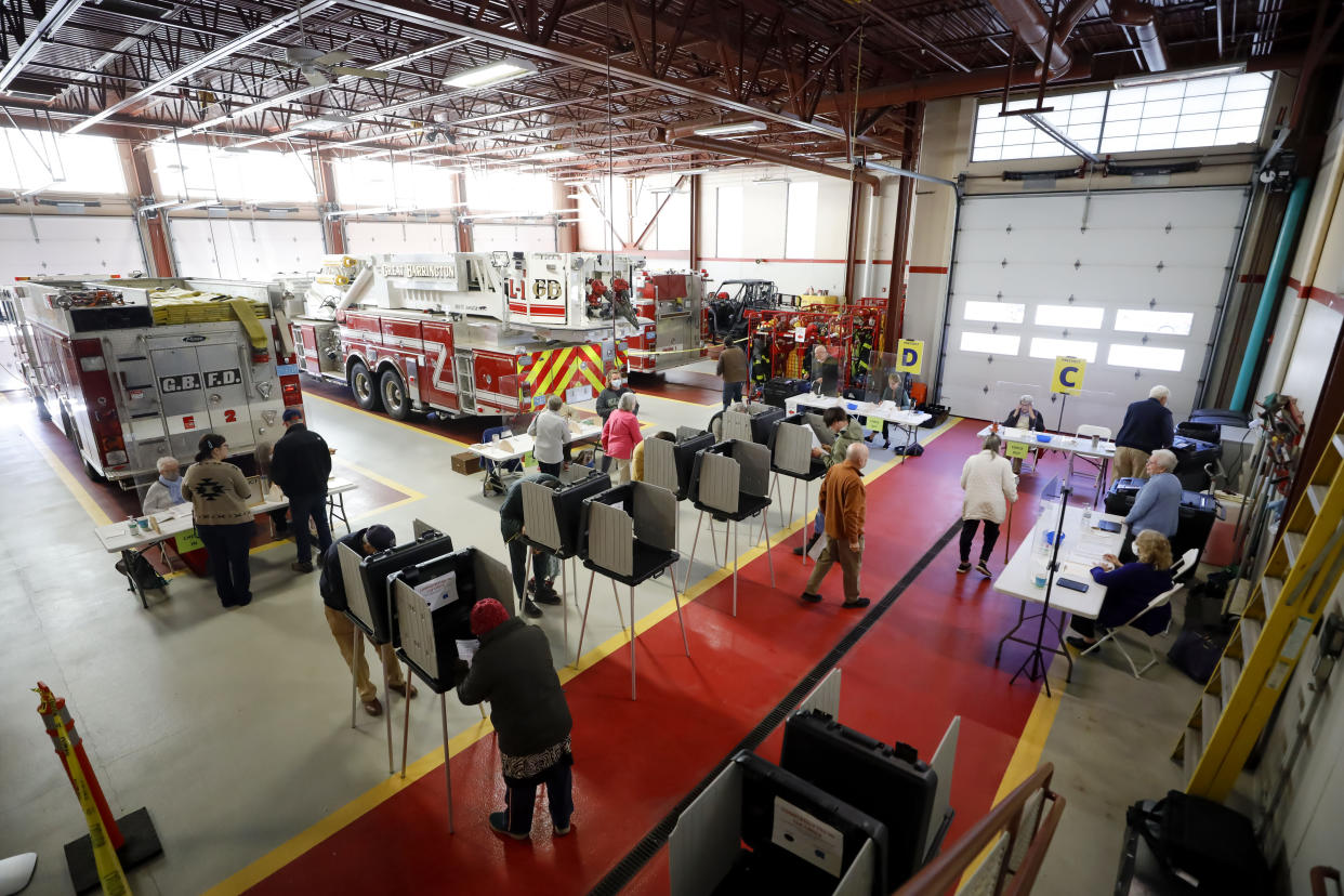 Great Barrington voters share the room with the fire engines as they cast their ballots at the town's fire station on election day on Tuesday, Nov. 8, 2022. (Stephanie Zollshan/The Berkshire Eagle via AP)