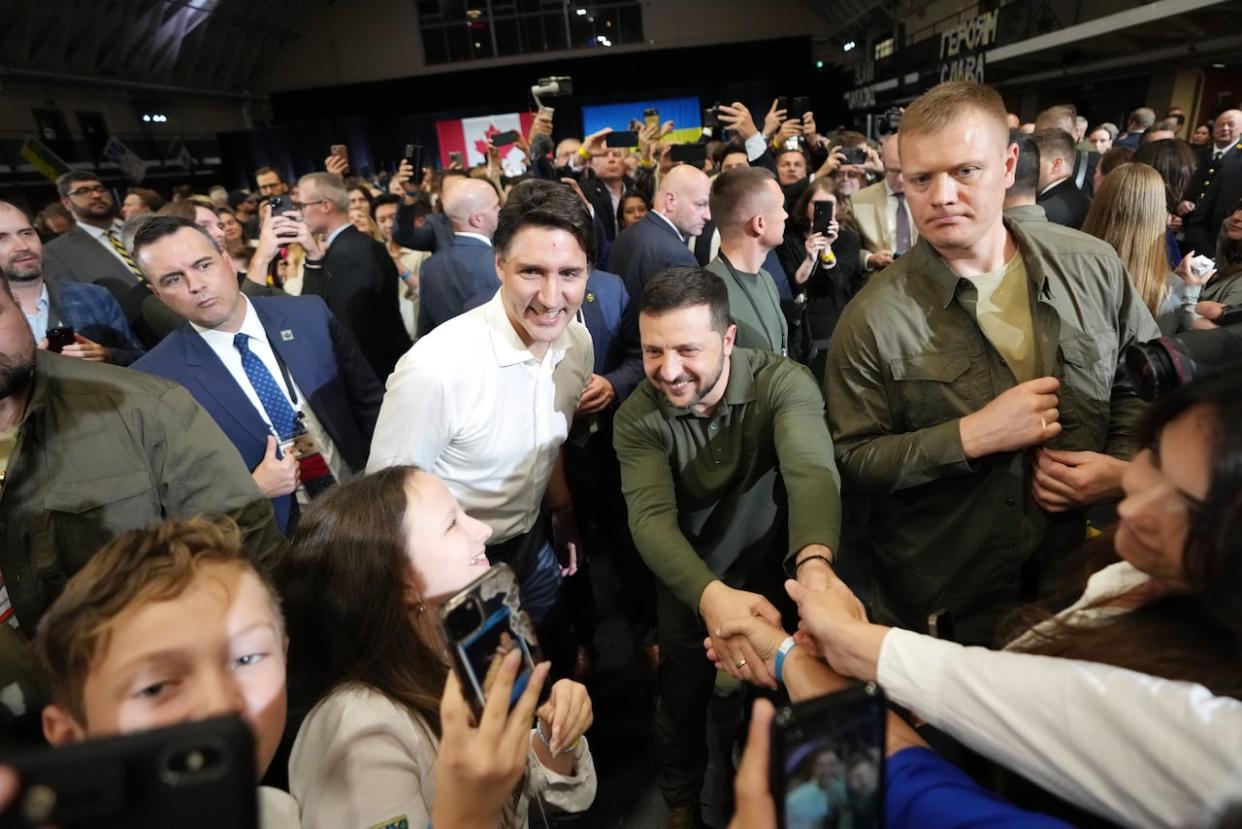 Prime Minister Justin Trudeau and Ukrainian President Volodymyr Zelenskyy greet supporters after a rally at the Fort York Armoury in Toronto on Friday, September 22, 2023. (Nathan Denette/The Canadian Press - image credit)