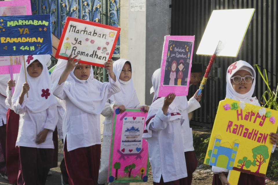 Indonesian students march during a parade ahead of Ramadan in Jakarta, Indonesia, Tuesday, March 21, 2023. Ramadan, the holy fasting month, is expected to begin on Thursday. Indonesia is the world's most populous Muslim nation. (AP Photo/Achmad Ibrahim)