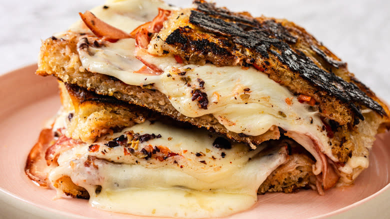 Side view of two slices of gooey, melty grilled cheese