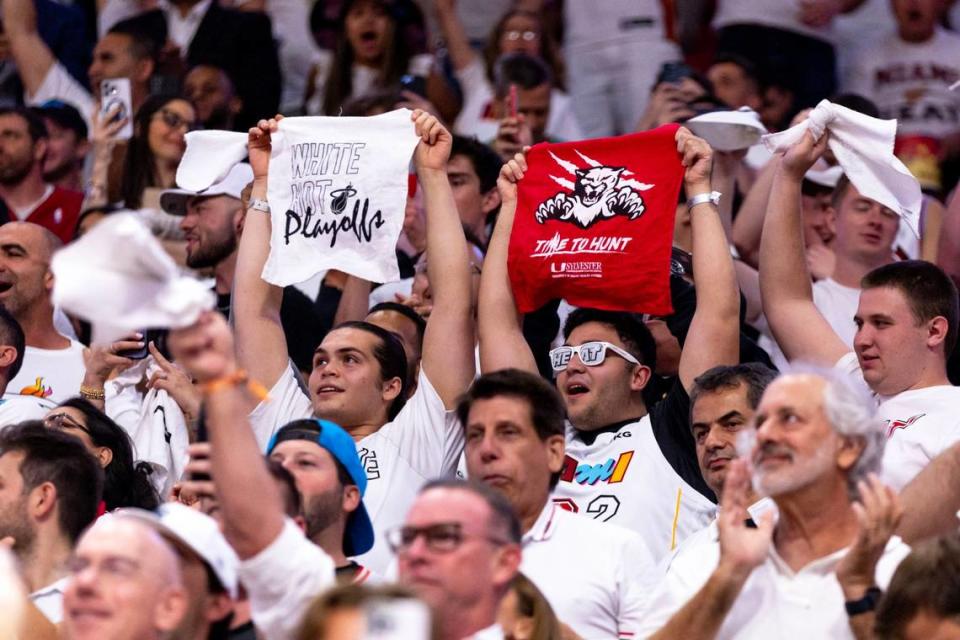 Miami Heat fans wave towels that read “White Hot Playoffs” and “Time to Hunt” during the second half of Game 3 of the NBA Eastern Conference Finals series agains thte Boston Celtics at Kaseya Center in Miami, Florida, on May 21, 2023. This is the first time Miami and Florida have ever made their respective conference finals in the same season and the first time two teams from the same market were No. 8 seeds and went on to make the conference finals.