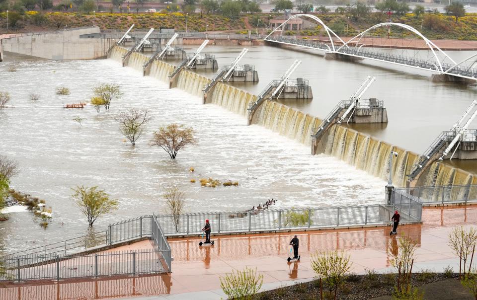 Flood water spills over Tempe Town Lake Dam due to the Salt River flooding as dams northeast of Phoenix release snowmelt runoff on March 15, 2023.