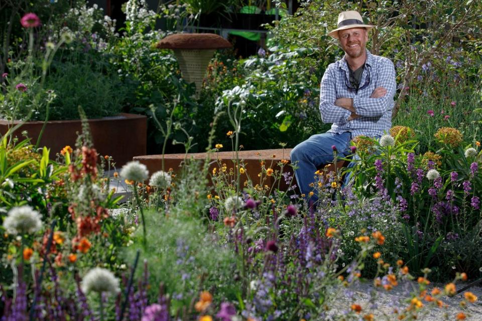 Garden designer Joe Swift in the BBC Studios Our Green Planet and RHS Bee Garden he designed, a space filled with plants for pollinators (RHS / Luke MacGregor/PA)