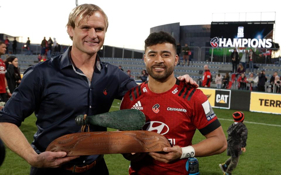 Crusaders coach Scott Robertson, left, and Richie Mo'unga pose with their trophy after the Super Rugby Aotearoa rugby game between the Crusaders and the Highlanders in Christchurch, New Zealand, Sunday, Aug. 9, 2020 - AP