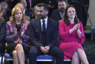 Scottish National Party leader candidates Ash Regan, left, and Kate Forbes applaud as Humza Yousaf, center, is announced new SNP leader, at Murrayfield Stadium, in Edinburgh, Scotland, Monday, March 27, 2023. Scotland’s governing Scottish National Party elected Yousaf as its new leader on Monday after a bruising five-week contest that exposed deep fractures within the pro-independence movement. The 37-year-old son of South Asian immigrants is set to become the first person of color to serve as Scotland’s first minister. (Andrew Milligan/PA via AP)