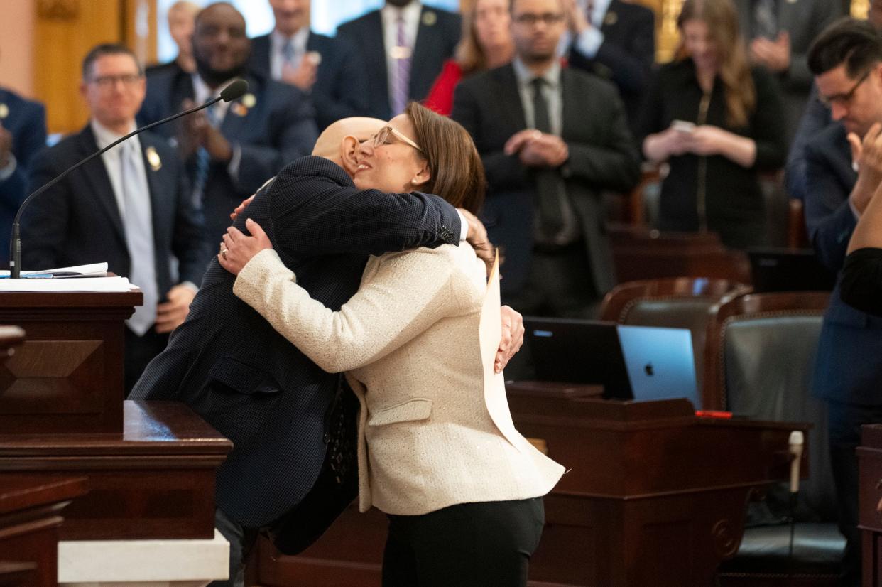 New Ohio House Rep. Beryl Brown Piccolantonio embraces her father, former Ohio Supreme Court Chief Justice Eric Brown, after he swears her in. Piccolantonio replaces state Rep. Mary Lightbody in Ohio's 4th House District, which covers northeastern Franklin County.