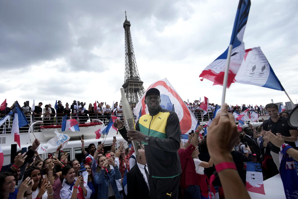 Paris 2024 Olympics Organizing Committee President Tony Estanguet, right, and former Jamaican athlete Usain Bolt attend a ceremony for the Olympic torch, Tuesday, July 25, 2023 in Paris. The torch that will be used to carry the Olympic flame around France and on its final leg at the Paris Games' opening ceremony next July is a sleek silver-colored cylinder of recycled steel that is gracefully tapered at both ends and is being made in limited numbers to save resources. (AP Photo/Christophe Ena)