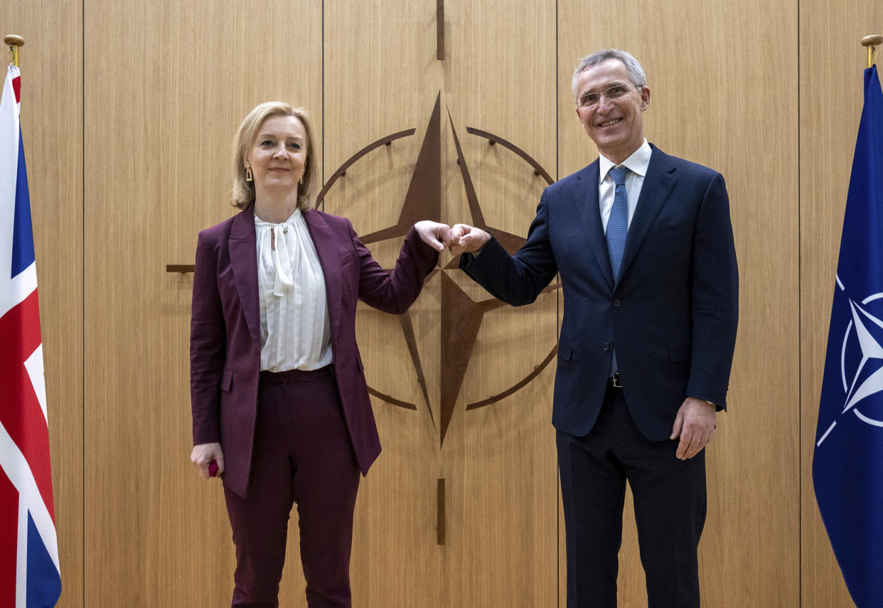 British Foreign Secretary Liz Truss, left, is greeted by NATO Secretary General Jens Stoltenberg prior to a meeting at NATO headquarters in Brussels, Monday, Jan. 24, 2022. (AP Photo/Olivier Matthys, Pool)