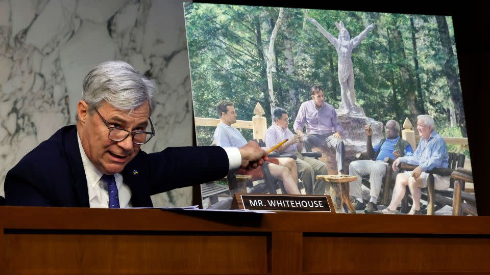Senate Judiciary Committee member Sen. Sheldon Whitehouse displays a copy of a painting featuring Clarence Thomas alongside other conservative leaders during a hearing on Supreme Court ethics reform on May 2, 2023, in Washington. The painting was commissioned by billionaire Texas Republican real estate developer Harlan Crow, who, according to a ProPublica investigation, invited Thomas on many luxury vacations. - Chip Somodevilla/Getty Images