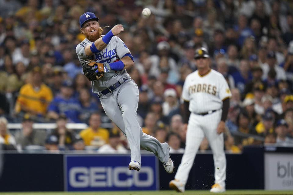 Los Angeles Dodgers third baseman Justin Turner throws to first for the out on San Diego Padres' Austin Nola during the fourth inning a baseball game Wednesday, Aug. 25, 2021, in San Diego. (AP Photo/Gregory Bull)