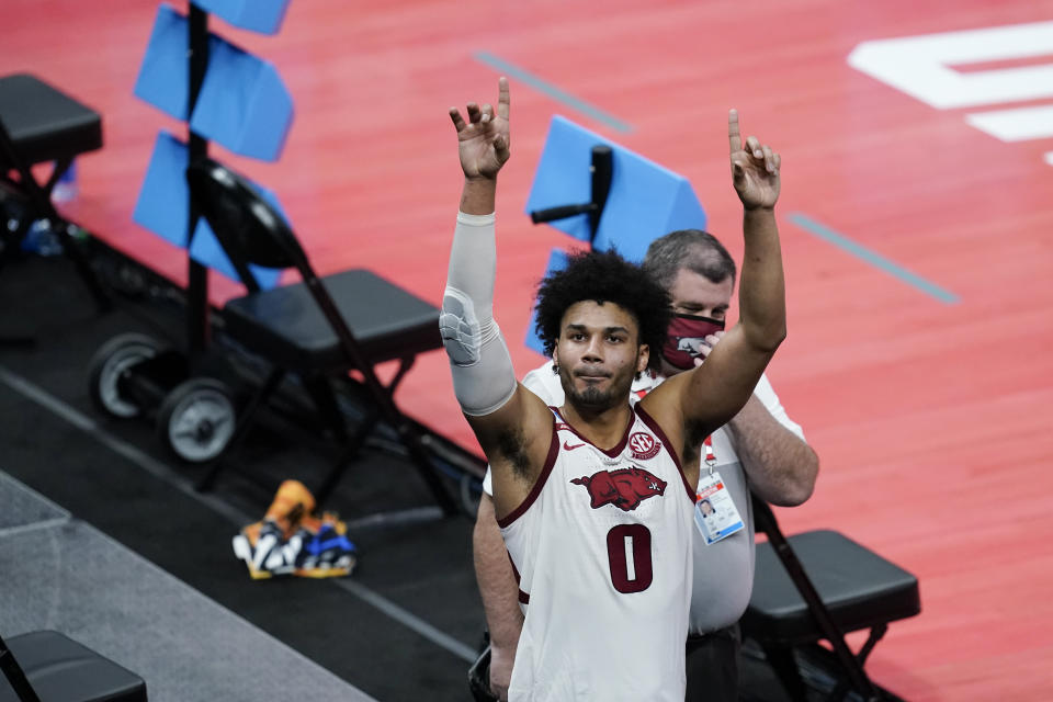 Arkansas' Justin Smith reacts to fans following a first round game against Colgate at Bankers Life Fieldhouse in the NCAA men's college basketball tournament, Friday, March 19, 2021, in Indianapolis. Arkansas defeated Colgate 85-68. (AP Photo/Darron Cummings)