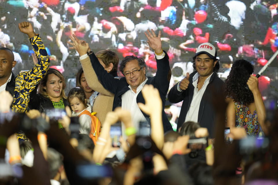 Presidential candidate Gustavo Petro, center, waves to supporters alongside his family on election night in Bogota, Colombia, Sunday, May 29, 2022. Petro will advance to a runoff contest in June after none of the six candidates in Sunday's first round got half the vote. (AP Photo/Fernando Vergara)