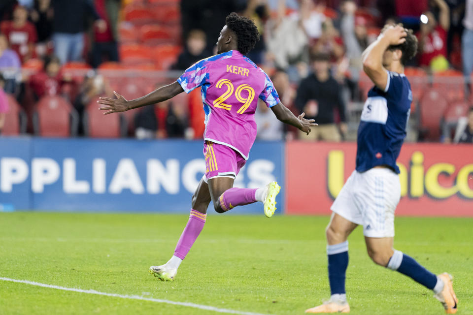 Toronto FC forward Deandre Kerr (29) celebrates after a goal as Vancouver Whitecaps defender Julian Gressel, right, reacts during second-half MLS soccer match action in Toronto, Saturday, Sept. 16, 2023. (Spencer Colby/The Canadian Press via AP)