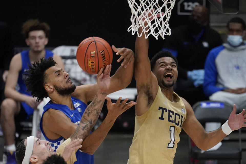 Kentucky forward Olivier Sarr, left, battles Georgia Tech guard Kyle Sturdivant, right, during the second half of an NCAA college basketball game Sunday, Dec. 6, 2020, in Atlanta. (AP Photo/John Bazemore)