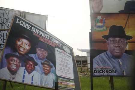 A billboard campaigning for the re-election of Bayelsa state governor Seriake Dickson is displayed next to one for People's Democratic Party candidates, along a road in Yenagoa in Nigeria's Bayelsa state February 28, 2015. REUTERS/Akintunde Akinleye