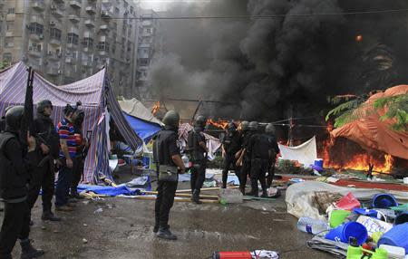 Riot police clear the area of members of the Muslim Brotherhood and supporters of deposed Egyptian President Mohamed Mursi, at Rabaa Adawiya square, where they are camping, in Cairo in this August 14, 2013 file picture. REUTERS/Stringer/Files