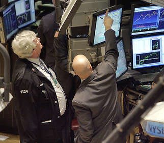 A pair of traders work on the floor of the New York Stock Exchange Tuesday. Wall Street rebounded sharply Tuesday, the Dow rising almost 417 points and 3.6 percent to close at 12,156.81 after the Federal Reserve and other central banks said they will pump $200 billion into the financial markets to help ease the strain from the credit crisis.Richard Drew | Associated Press