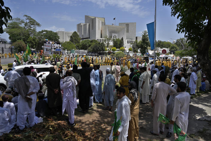 Supporters of Pakistan Democratic Movement, an alliance of the ruling political parties, take part in a rally outside the Supreme Court in Islamabad, Pakistan, Monday, May 15, 2023. Convoys of buses and vehicles filled with Pakistani pro-government supporters are flooding the main road leading to the country's capital on Monday to protest the release of former Prime Minister Imran Khan. (AP Photo/Anjum Naveed)