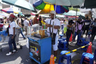 Venezuelan Giovanny Tovar waits for customers at his tequeños or fried breaded cheese sticks' street cart, in Lima, Peru, Saturday, April 13, 2024. Tovar is one of millions of Venezuelans living abroad who will not be able to cast his vote in the July 28th presidential election. (AP Photo/Martin Mejia)