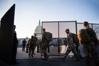 <p>Members of the National Guard arrive to the East Front of the Capitol in Washington on Tuesday, Jan. 12, 2021.</p>