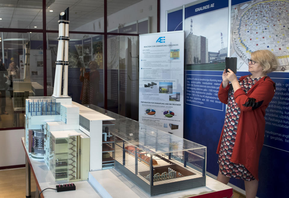 In this photo taken on Tuesday, July 16, 2019, a tourist take a picture of a model of the Ignalina nuclear power plant (NPP) at the information center of NPP in Visaginas some 160km (100 miles) northeast of the capital Vilnius, Lithuania. The HBO TV series “Chernobyl” featuring Soviet era nuclear nightmares is drawing tourists to the atomic filming locations and helping Lithuania grow as a tourist destination. (AP Photo/Mindaugas Kulbis)