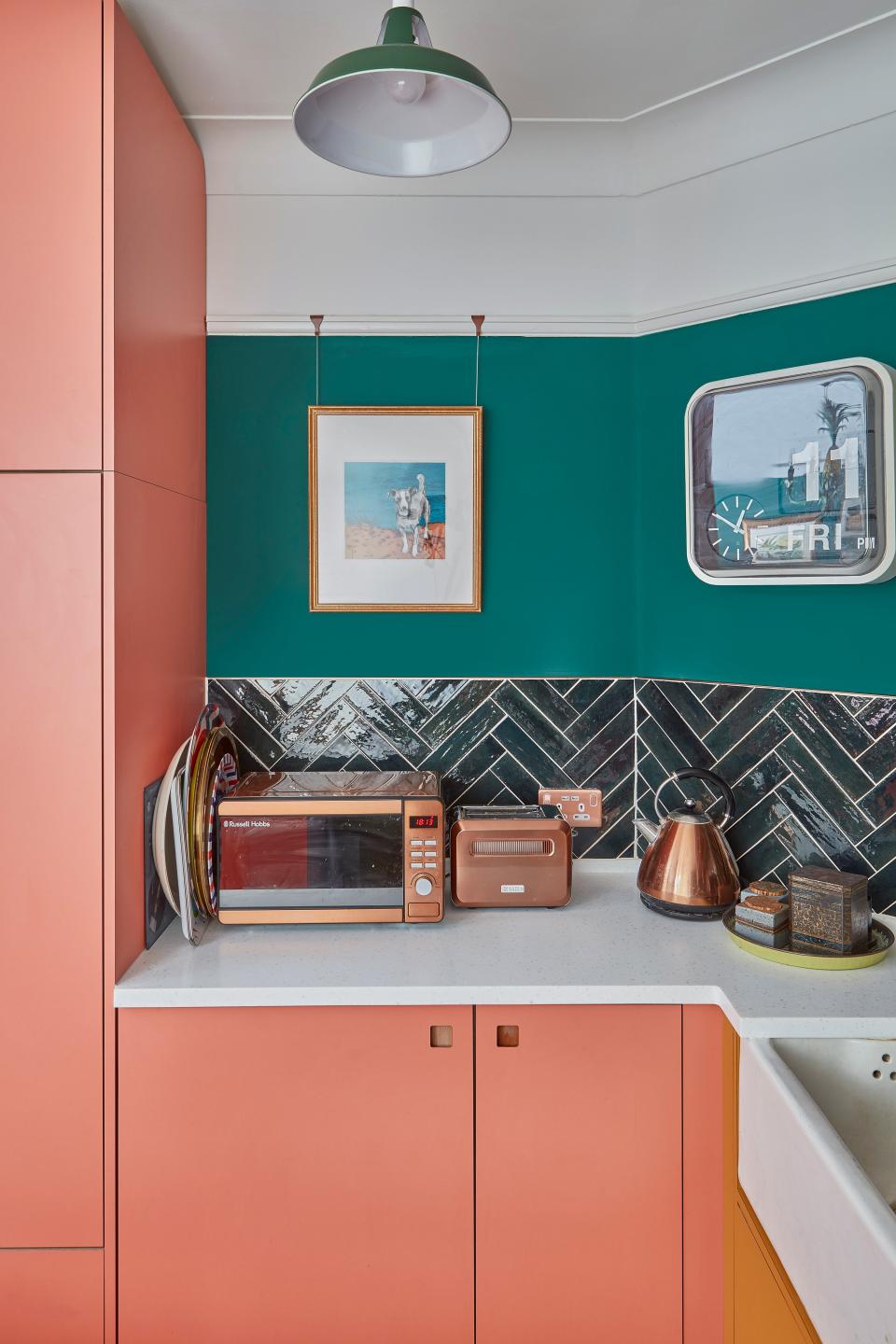 A copper microwave, toaster, and kettle match the faucet.