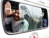 Afghan prisoner Fida Mohammad waves from an ICRC bus after leaving a Kabul prison following his release from the U.S. naval base at Guantanamo Bay in Cuba March 16, 2004. Twenty-three Afghans held at the U.S. naval base at Guantanamo Bay in Cuba for up to two-and-a-half years were released in Kabul on Tuesday and complained of ill-treatment by their American captors. (REUTERS/Ahmad Masood AM/SH)