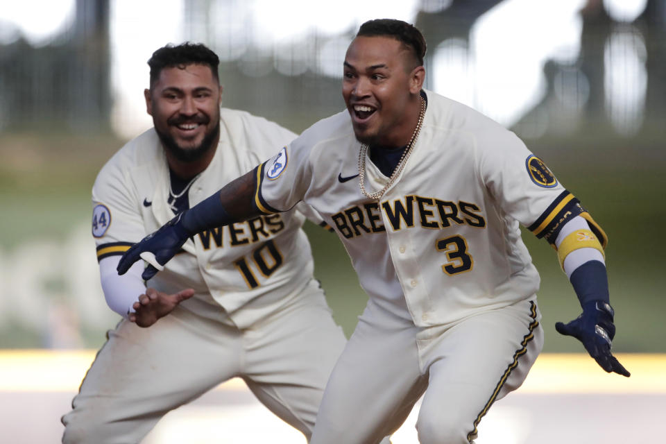 Milwaukee Brewers' Orlando Arcia celebrates with teammates after driving in the winning run during the 10th inning of the team's opening-day baseball game against the Minnesota Twins on Thursday, April 1, 2021, in Milwaukee. (AP Photo/Aaron Gash)