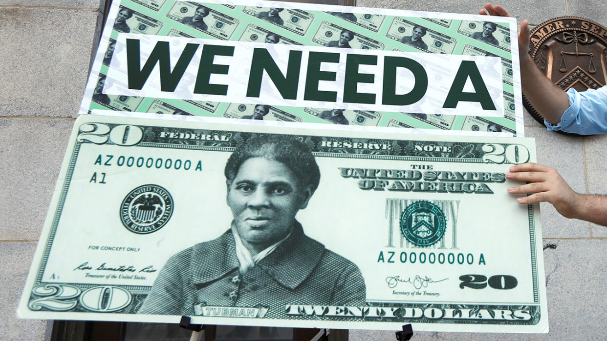 Capitol Hill staff member places signs before a news conference by House Majority Leader Steny Hoyer (D-MD) on Treasury Secretary Steve Mnuchin's decision to indefinitely delay putting famous abolitionist Harriet Tubman on the new $20 bill, on the steps of the Treasury Department in Washington on June 27, 2019. (Yuri Gripas/Reuters)