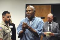 FILE - In this July 20, 2017, file photo, former NFL football star O.J. Simpson reacts after learning he was granted parole at Lovelock Correctional Center in Lovelock, Nev. Simpson got into a series of minor legal scrapes following his 1995 acquittal of murder charges in the deaths of his wife Nicole Brown Simpson and her friend Ronald Goldman. (Jason Bean/The Reno Gazette-Journal via AP, Pool, File)