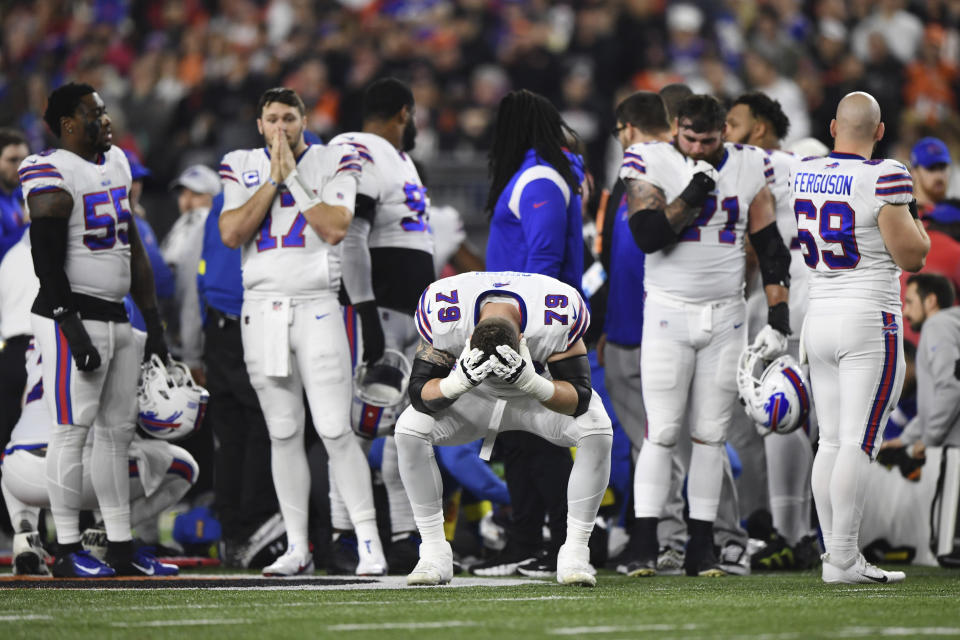 Buffalo Bills offensive tackle Spencer Brown (79) pauses as Damar Hamlin is examined by medical staff during the first half of an NFL football game against the Cincinnati Bengals, Monday, Jan. 2, 2023, in Cincinnati. (AP Photo/Emilee Chinn)