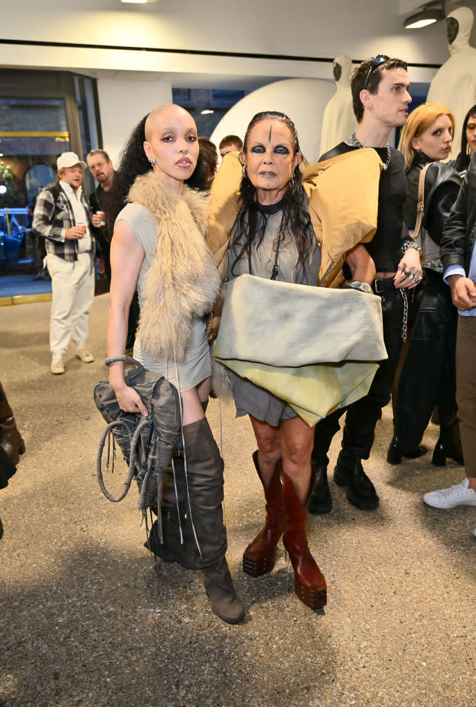 FKA Twigs (L) in over-the-knee boots, slouchy boots, gray shoes, and Michele Lamy attend the Rick Owens SS25 With Michele Lamy collection launch at Dover Street Market on July 02, 2024 in London, England. (Photo by Jed Cullen/Dave Benett/Getty Images)