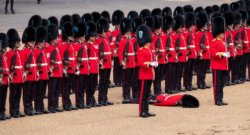 <span class="caption">A member of the Coldstream Guards succumbs to the heat, June 2022.</span> <span class="attribution"><a class="link " href="https://www.shutterstock.com/image-photo/london-uk-june-2022-soldier-uniform-2165811619" rel="nofollow noopener" target="_blank" data-ylk="slk:Lois GoBe/Shutterstock;elm:context_link;itc:0;sec:content-canvas">Lois GoBe/Shutterstock</a></span>