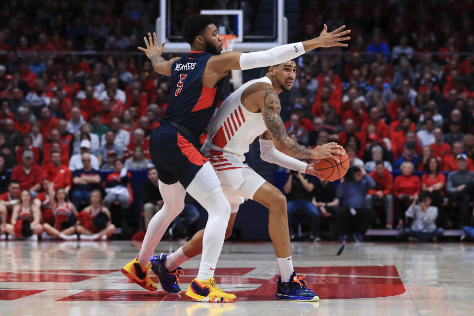 Duquesne's Marcus Weathers (5) defends against Dayton's Obi Toppin (1) in the first half of an NCAA college basketball game, Saturday, Feb. 22, 2020, in Dayton, Ohio. (AP Photo/Aaron Doster)