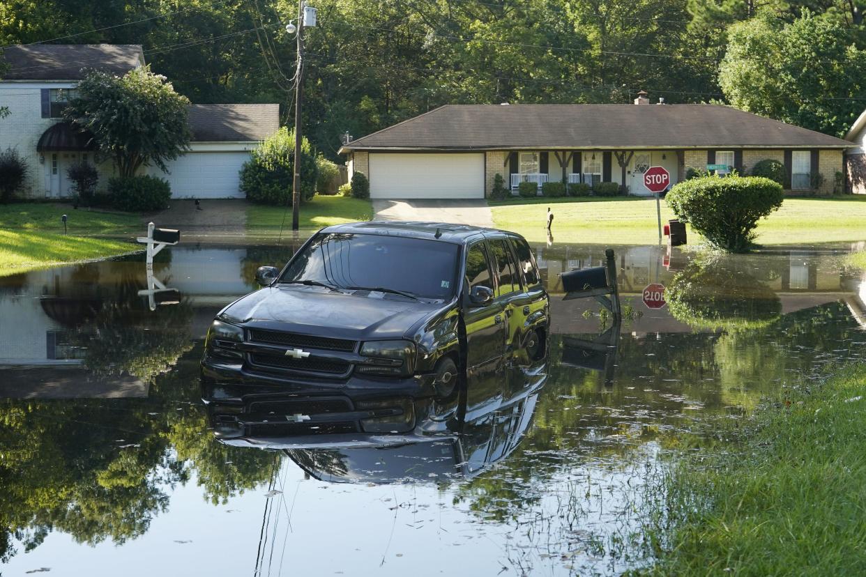An SUV rests in flood waters in this northeast Jackson, Miss., neighborhood.
