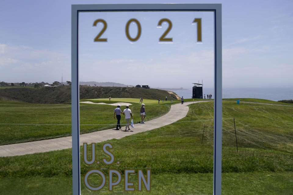 Fans walk along the third fairway during a practice round of the U.S. Open Golf Championship, Tuesday, June 15, 2021, at Torrey Pines Golf Course in San Diego. (AP Photo/Jae C. Hong)