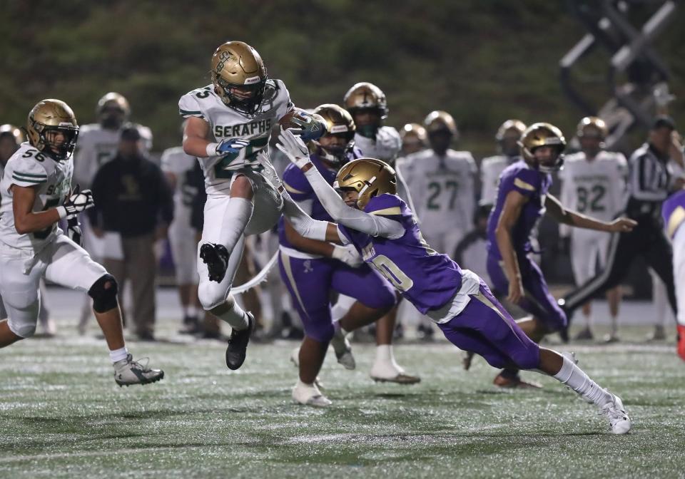 St. Bonaventure's Koen Glover leaps to get past St. Augustine's Kyle Cooper during the CIF-State Division 1-A regional final on Dec. 2.