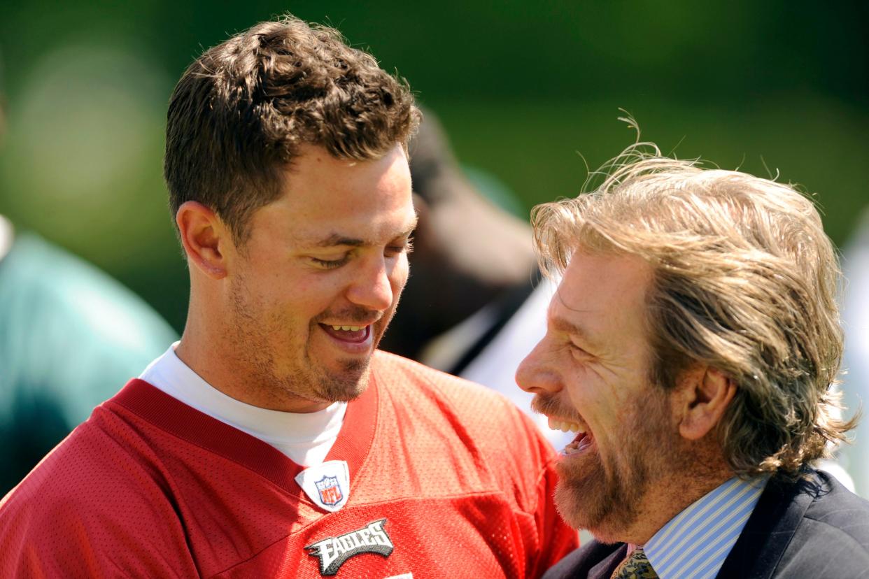 Quarterback Kevin Kolb shares a laugh with local sports reporter Howard Eskin during the Eagles' 2010 minicamp.