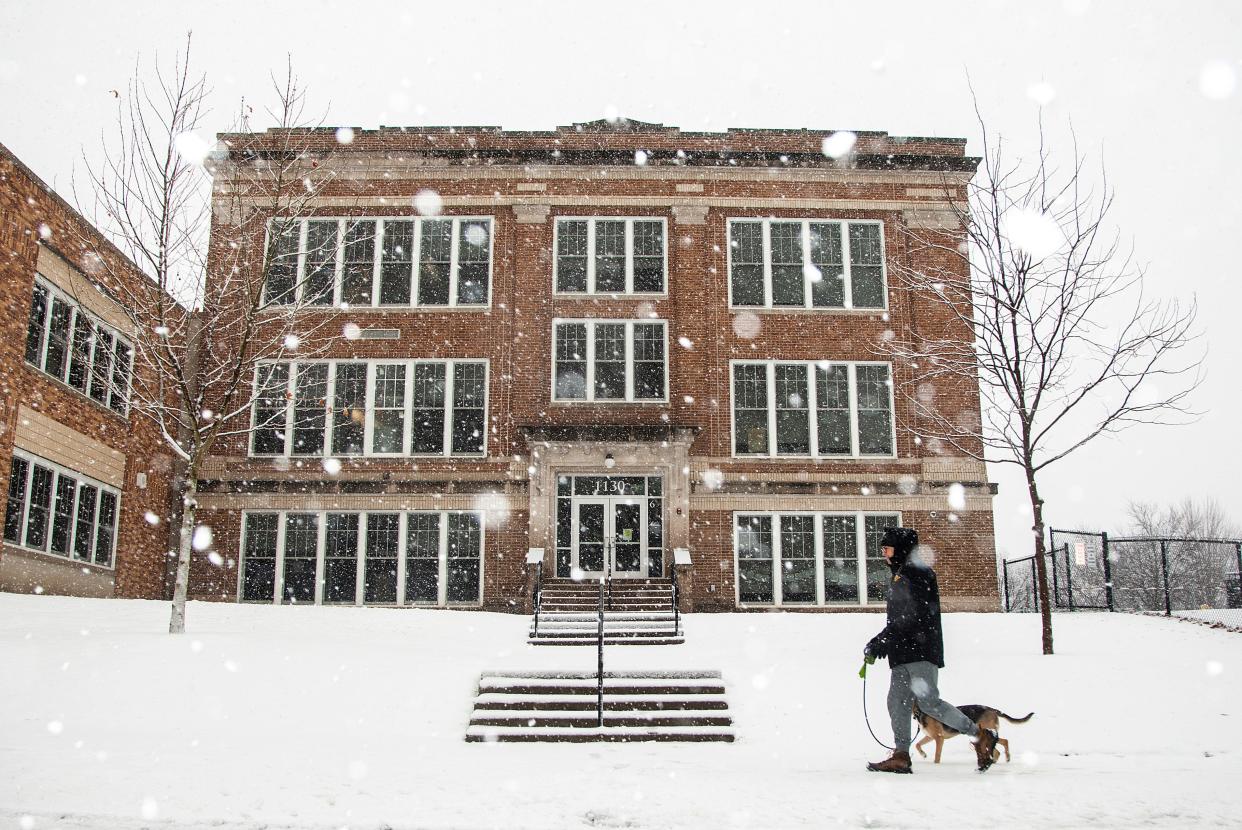 Snow falls in front of Longfellow Elementary School during a winter weather advisory, Thursday, Feb. 9, 2023, in Iowa City, Iowa. The Iowa City Community School District canceled classes Thursday.