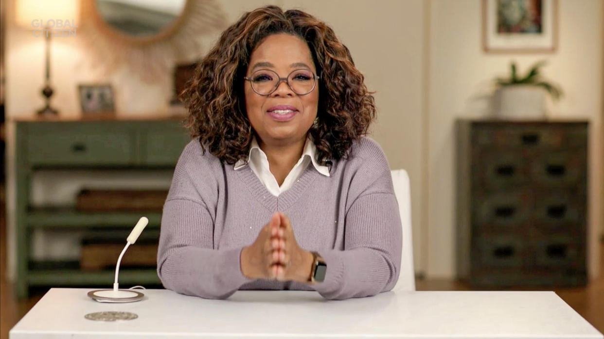 Oprah Winfrey sitting at a desk