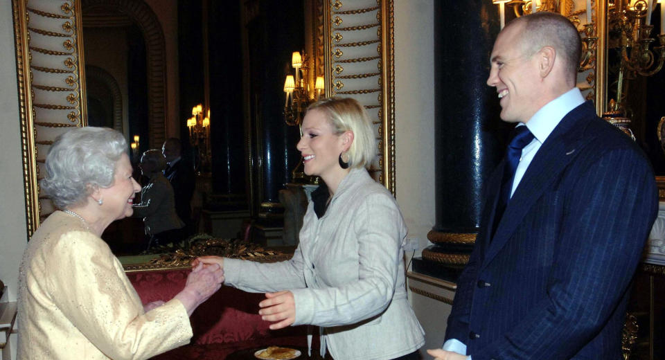 Queen Elizabeth ll greets her granddaughter, Zara Phillips, and boyfriend, English rugby player Mike Tindall,  at a Buckingham Palace reception for the country's top achievers on December19, 2006  in London, England.  