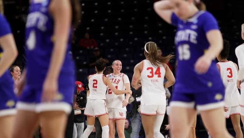 Utah guard Ines Vieira (2), guard Kennady McQueen and teammates celebrate a win against South Dakota State in a first-round college basketball game in the women's NCAA Tournament in Spokane, Wash., Saturday, March 23, 2024.