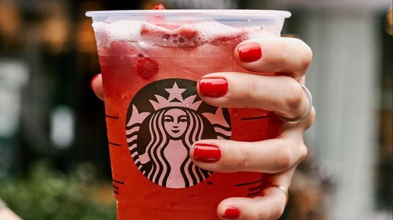 Hand holding a Starbucks Strawberry Açaí Refresher
