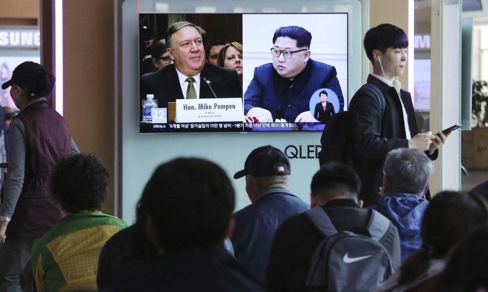 A TV news programme in South Korea shows photographs of Mike Pompeo and Kim Jong-un