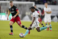 New England Revolution forward DeJuan Jones (24) passes the ball past D.C. United defender Julian Gressel (31) during the second half of an MLS soccer match, Wednesday, Oct. 20, 2021, in Washington. The Revolution won 3-2. (AP Photo/Alex Brandon)