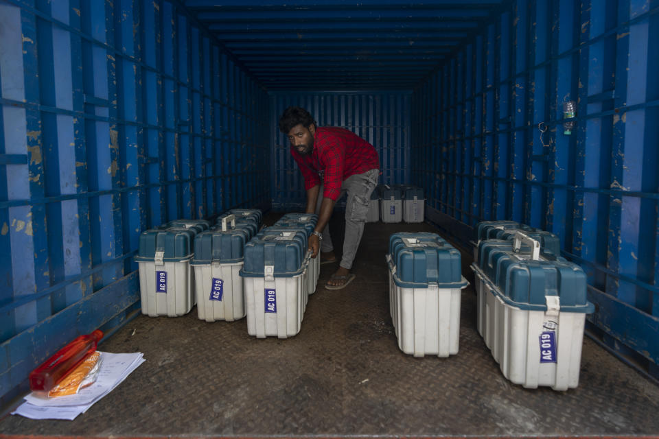 A man loads Electronic Voting Machines and other election material on to a truck for distribution on the eve of the first round of voting in the six-week-long national election in Chennai, India, April 18, 2024. (AP Photo/Altaf Qadri)