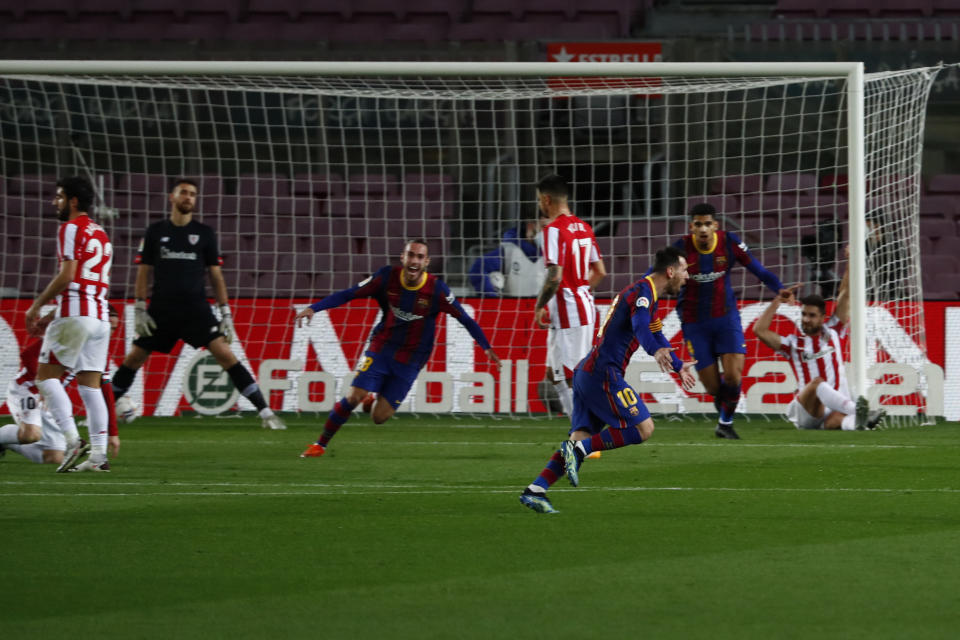 Barcelona's Lionel Messi, right, celebrates after scoring his side's opening goal during the Spanish La Liga soccer match between FC Barcelona and Athletic Bilbao at the Camp Nou stadium in Barcelona, Spain, Sunday, Jan. 31, 2021. (AP Photo/Joan Monfort)