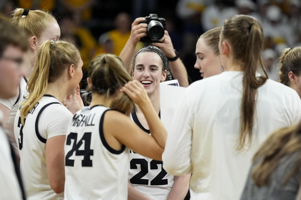 Iowa guard Caitlin Clark (22) celebrates with teammates after a second-round college basketball game against West Virginia in the NCAA Tournament, Monday, March 25, 2024, in Iowa City, Iowa. Iowa won 64-54. (AP Photo/Charlie Neibergall)