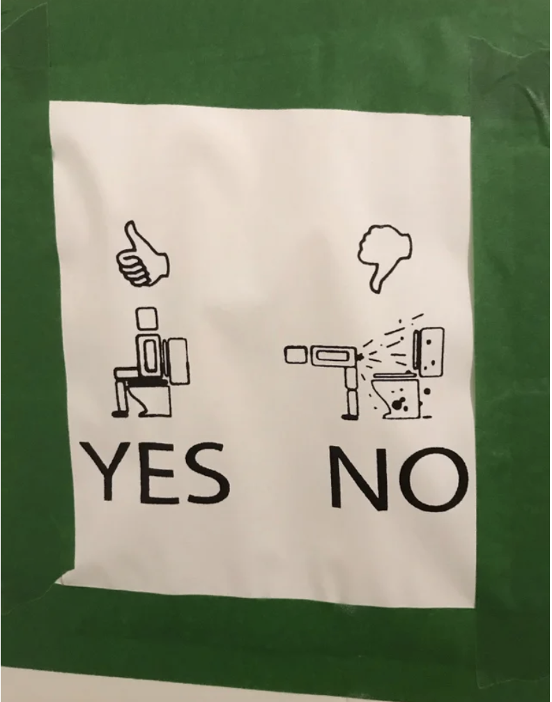 A bathroom sign that has a thumbs up and "yes" printed next to someone sitting on the toilet, and a thumbs down and "no" printed next to someone bending over next to the toilet and spraying poop in various directions